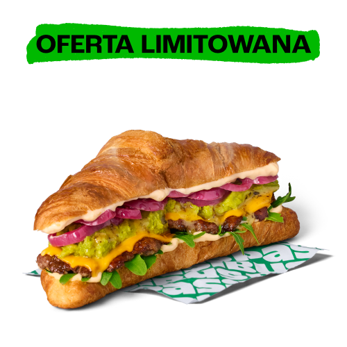 Duża croissant-kanapka z kotletami, roztopionym serem, guacamole, czerwoną cebulą i rukolą. U góry zielony napis: OFERTA LIMITOWANA.